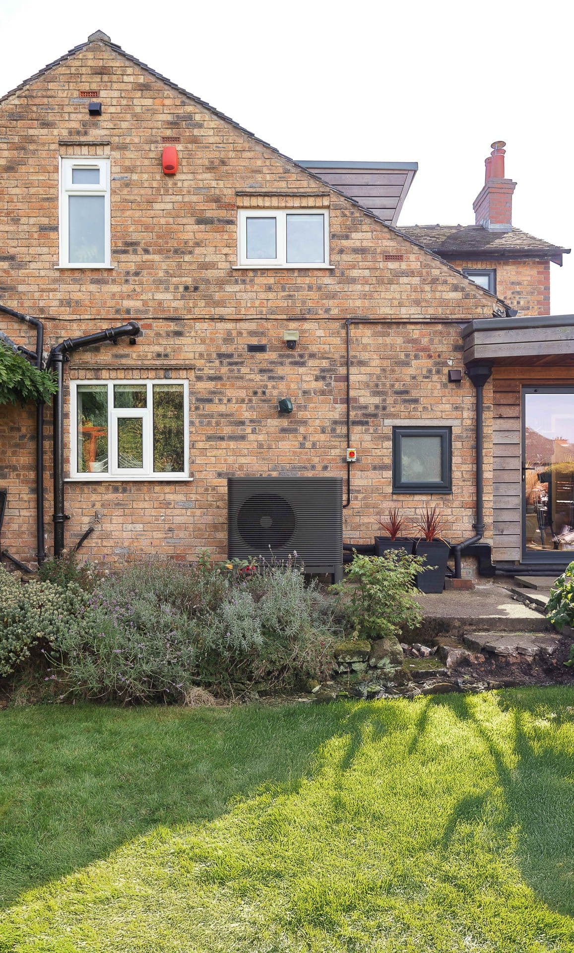 The outside of a home with an Aira Heat Pump outside