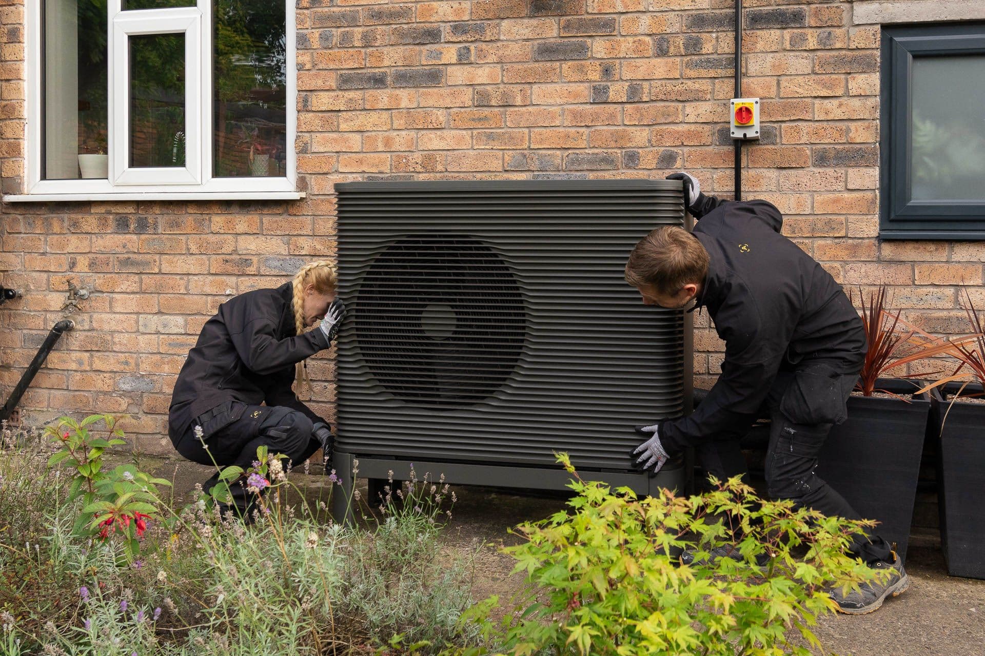 Two Aira Technicians installing an Aira Heat Pump 